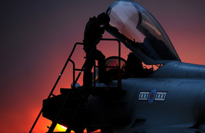 A Royal Air Force Typhoon pilot enters his cockpit at Gioia del Colle air base in southern Italy