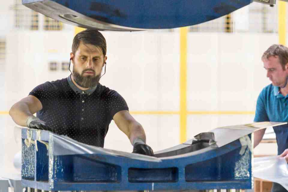 Impression Technologies employee working on the pressing process.