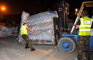 RAF personnel prepare to load aid for Pakistan onto a C-17