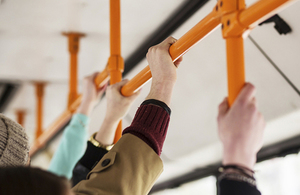 Holding bus handrail.