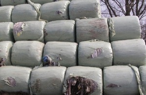 Image shows waste dumped on land, wrapped in bales