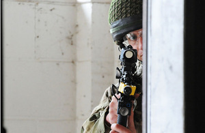 A paratrooper takes part in a compound clearance exercise