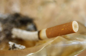 A cigarette in an ash tray.