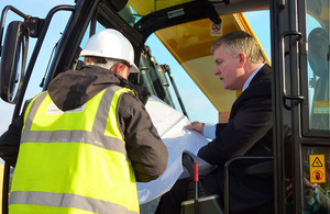 Mark Prisk sitting in a JCB