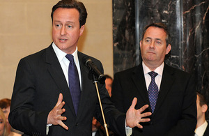 Defence Secretary Dr Liam Fox (right) listens as Prime Minister David Cameron addresses staff at MOD's Main Building