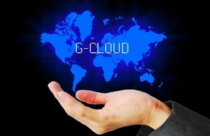 Hand with world image hovering over it overlaid with word G-Cloud