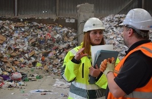 Image shows Environment Agency officer speaking to waste site operator