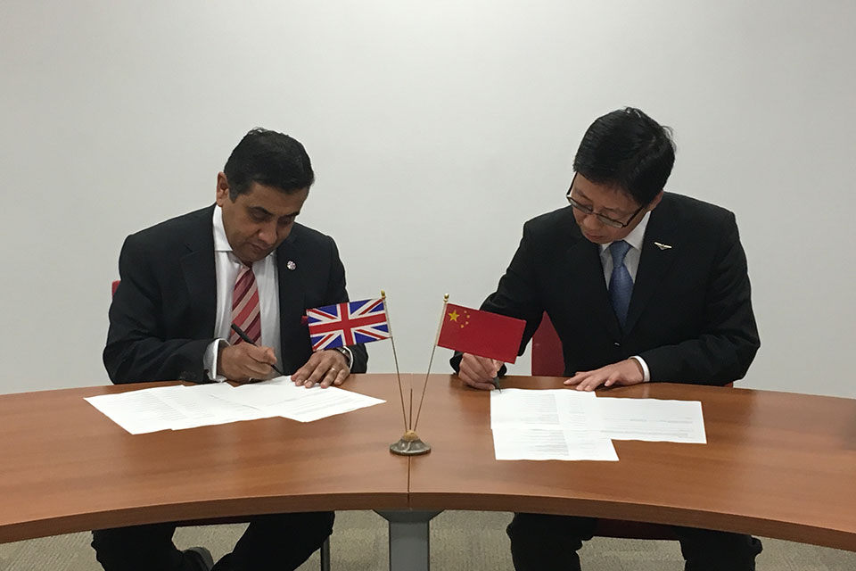 Aviation Minister Lord Ahmad agreeing the new deal with Chinese officials.