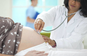 Pregnant woman being seen by a doctor