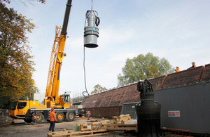 Crane installing a pump