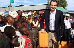 Minister James Wharton meets beneficiaries at UK aid funded water and sanitation facility in Eastern DRC. Photo: Alexandra Jonnaert / Mercy Corps