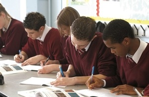 Pupils writing in exercise books