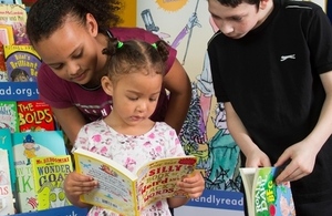 Three children looking at books