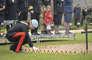 Prince Harry plants a cross for Lance Corporal of Horse Jonathan Woodgate at the opening of the Royal British Legion Wootton Bassett Field of Remembrance [Picture: Ben Birchall/PA Wire 2010]