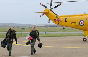 The Captain of 'Rescue 122' (left) and Flight Lieutenant William Wales discuss the rescue mission they have just completed [Picture: Senior Aircraftman Dek Traylor, Crown Copyright/MOD 2010]