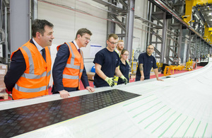 Greg Clark examines a wind turbine blade in the factory