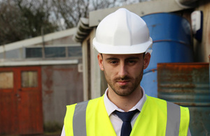 Man in hard hat and fluorescent vest.