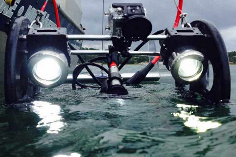 Unmanned marine survey vehicle entering the water.