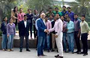 Gaist managing director Steve Birdsall shaking hands with Optimint's managing director, Deepak Dalal and his team.