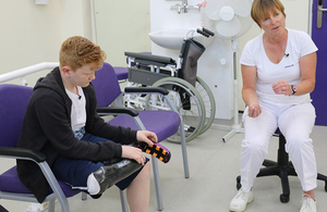 Child wearing new prosthesis talking to a doctor