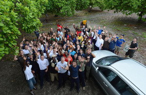 Members of HMS Northumberland's company and the Kigamboni Community Centre wave for the camera in Dar es Salaam [Picture: Leading Airman (Photographer)Maxine Davies, Crown Copyright/MOD 2013]