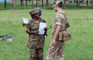 A member of the British Peace Support Team East Africa instructs a Ugandan soldier at Singo