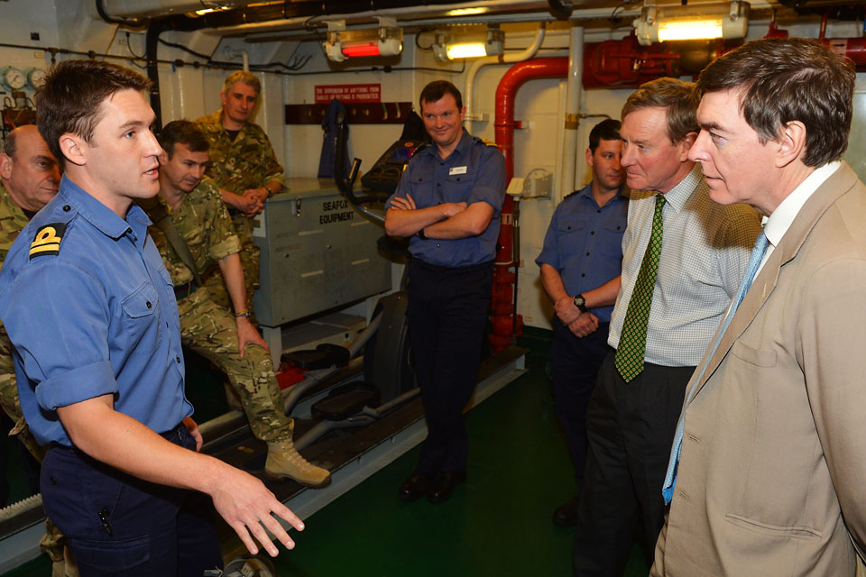 Andrew Robathan and Philip Dunne are briefed on board a Royal Navy warship
