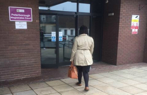 Lady walking into a court building
