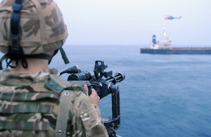 A member of HMS Monmouth's force protection team provides cover during the boarding of the MV Caravos Horizon that had been assaulted by suspected pirates [Picture: Leading Airman (Photographer) Stuart Hill, Crown Copyright/MOD 2011]