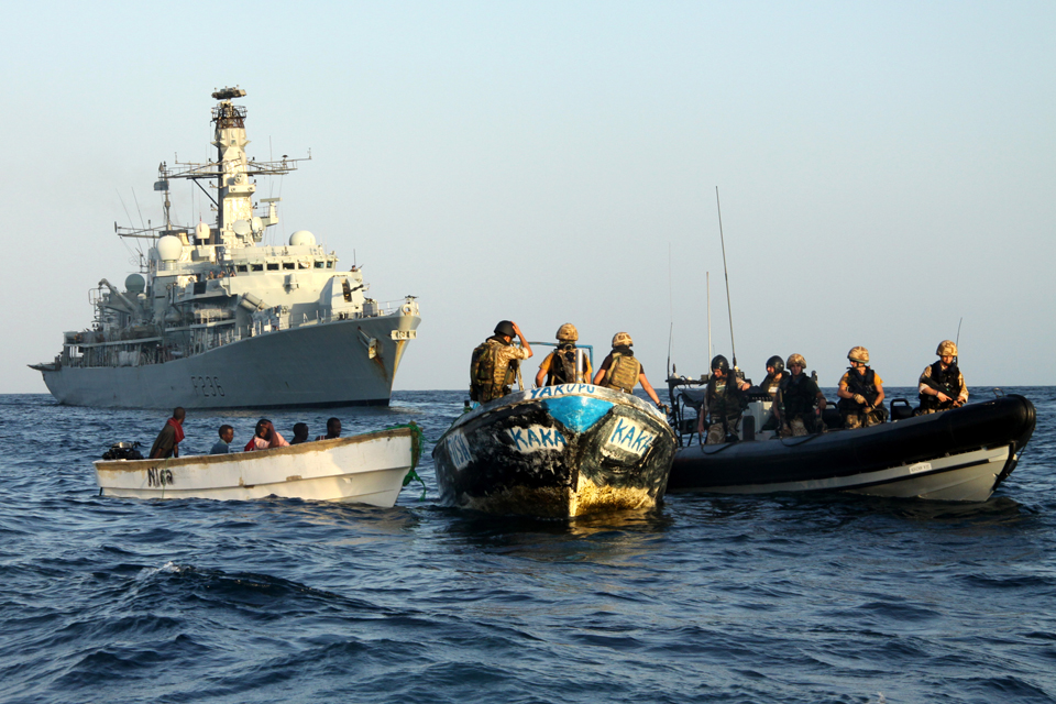 A boarding team from HMS Montrose confiscates suspected pirates' gear