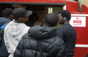 Photo of children buying food at Box Chicken van