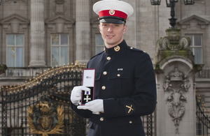 Marine Mark Williams with his Military Cross at Buckingham Palace [Picture: Sergeant Adrian Harlen, Crown Copyright/MOD 2013]