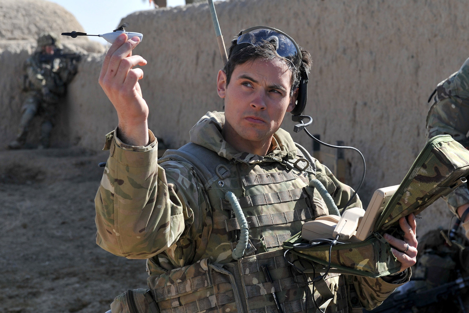 Sergeant Scott Weaver launches a Black Hornet Nano Unmanned Air Vehicle from a compound in Afghanistan
