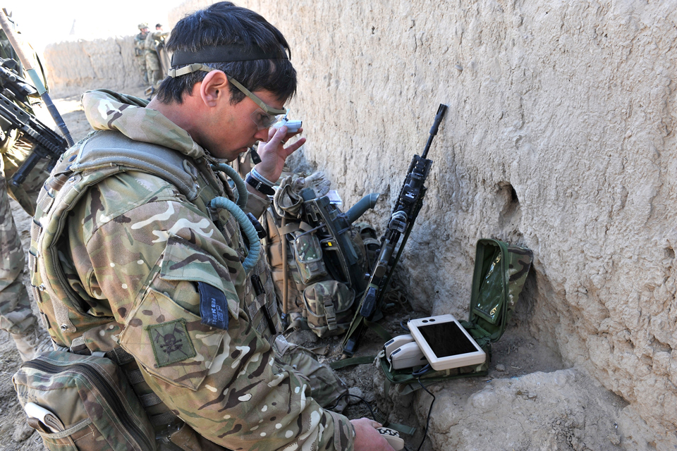 Sergeant Scott Weaver launches a Black Hornet Nano Unmanned Air Vehicle from a compound in Afghanistan