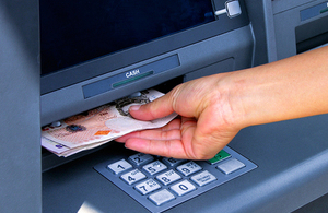 Person withdrawing money from a cashpoint