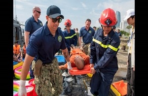 UK, USA and Vietnamese personnel evacuate a 'casualty' during Exercise PP17