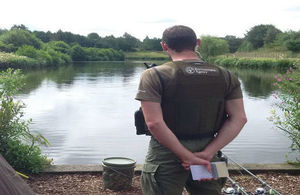 Fisheries enforcement officer checking licences