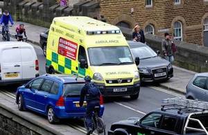 An ambulance trying to negotiate its way through a congested city street.