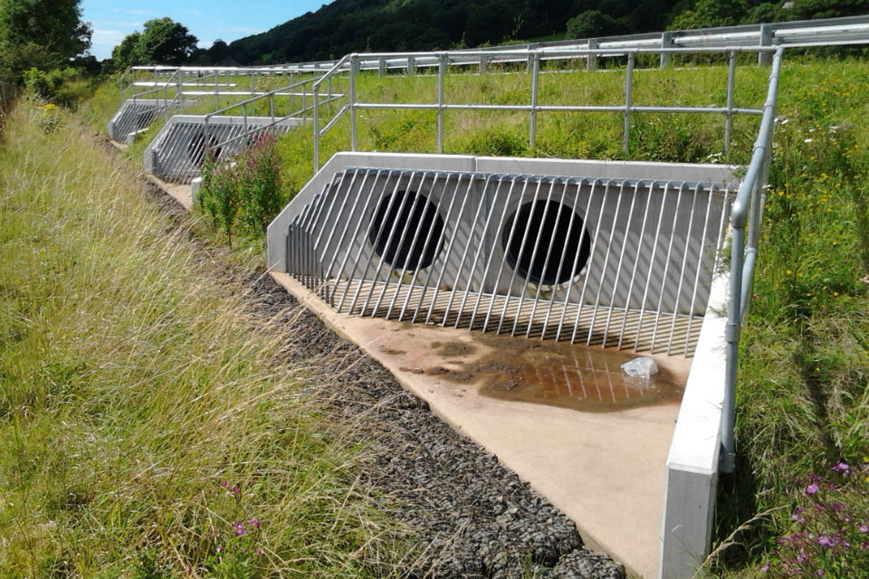 New drainage culverts under the road show how high the carriageway has been raised