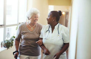 Elderly patient walks with a doctor