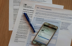 probate forms on table with mobile phone