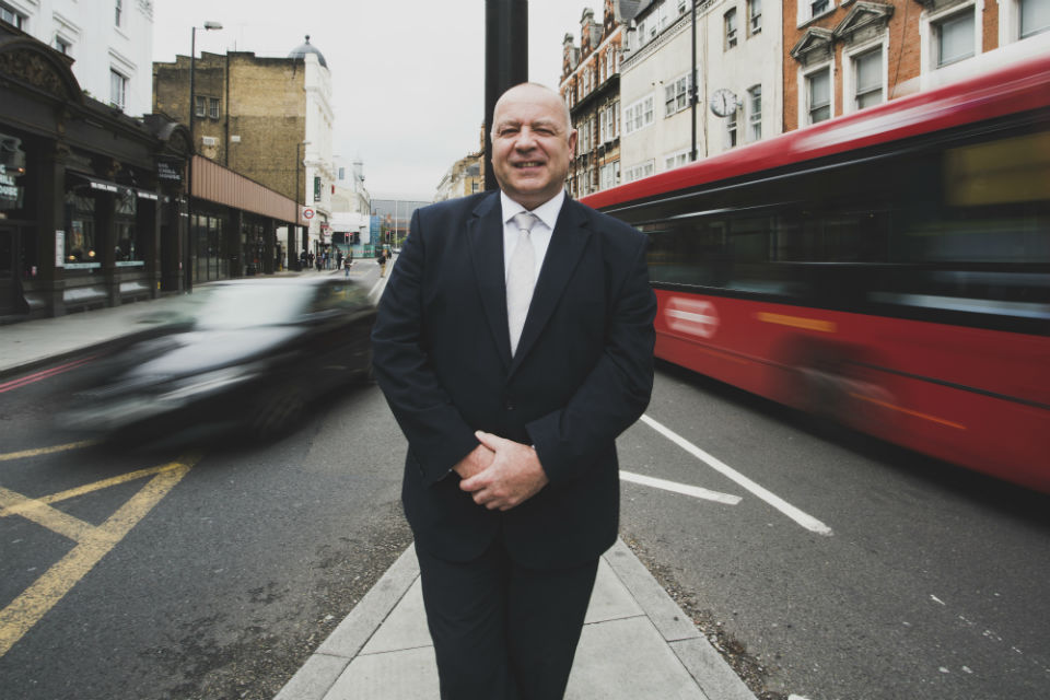 Neil Herron, founder and CEO of Grid Smarter Cities, stands on a traffic island.