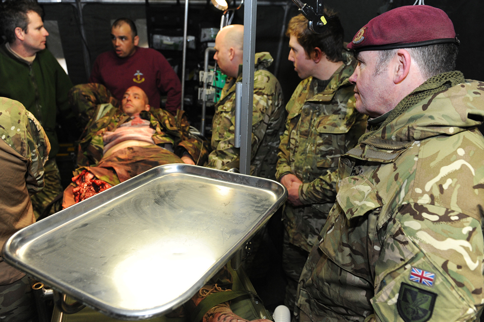 Troops from 144 Parachute Medical Squadron discuss methods of treatment