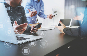 Close up of businessmen with laptops and mobile phones