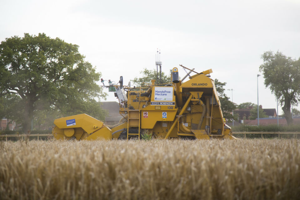 Combine harvester in barley field