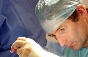 Surgeon operating.