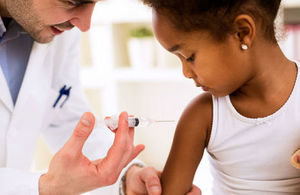 Doctor gives injection to young girl