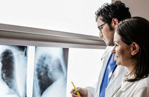Two doctors examine x-ray film