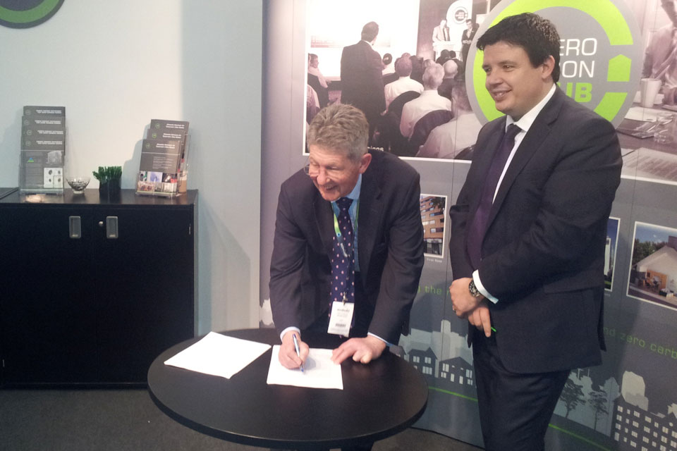 Don Foster signing a document