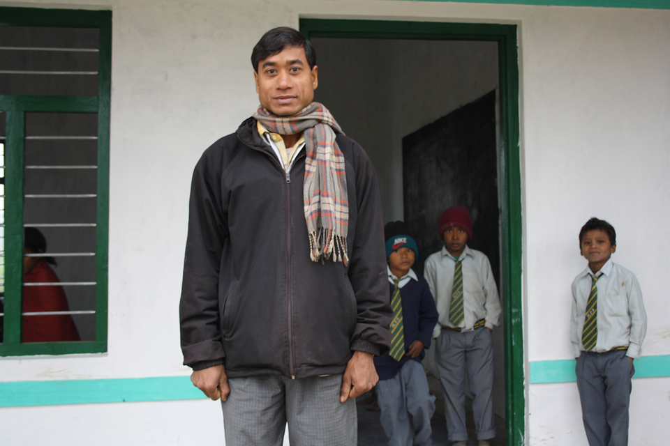 Nokhiram Kumar, Headmaster at Manakaman Primary School in Kailali stands in front of the new school building. Picture: Robert Stansfield/DFID